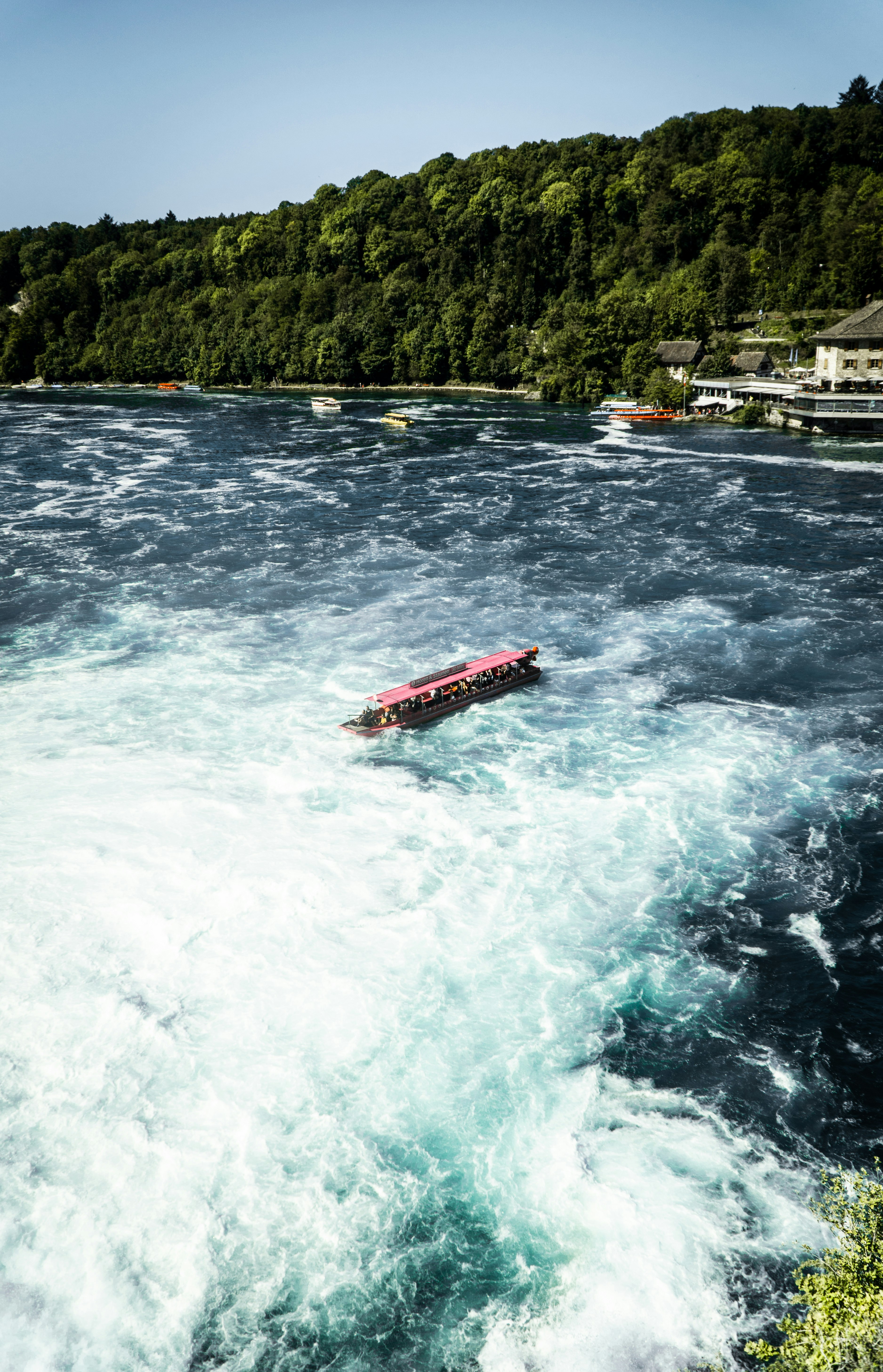 red and white boat on water during daytime